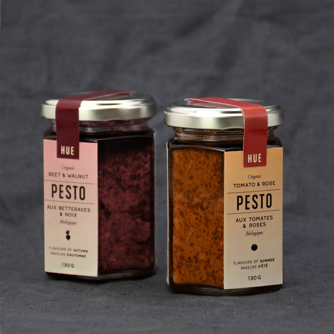 Pesto packaging showing two containers, one fall-themed and one summer-themed.